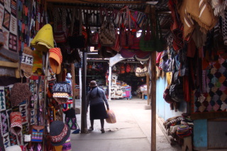 a woman carrying a bag in a market