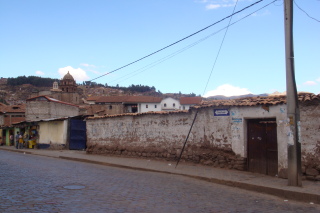 a street with a brick wall and buildings