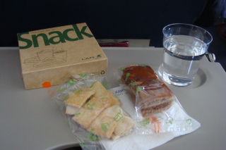 a sandwich and a glass of water on a tray