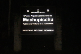 a sign at night with white text