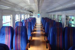 a row of blue seats in a train