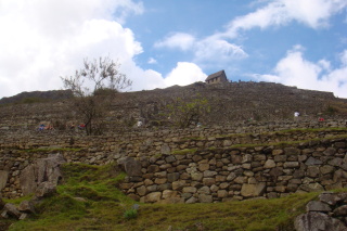 a stone wall with a building on the top