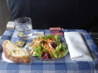 a plate of salad and a glass of water