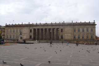 a building with many pigeons in front of it