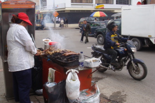 a man cooking food on a motorcycle