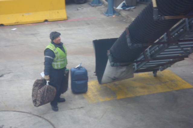a man in a safety vest holding luggage