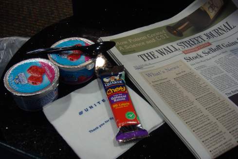 a newspaper and food on a table