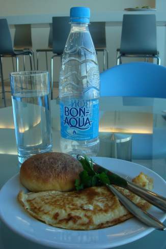a plate of food and a bottle of water