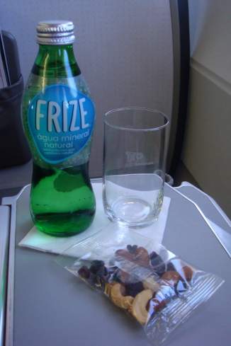 a bottle of mineral water next to a glass