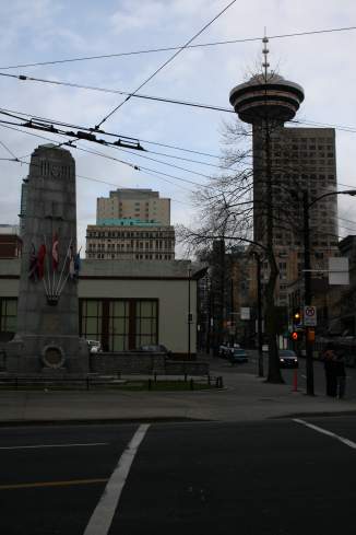 a city street with a monument and buildings