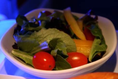 a bowl of salad with tomatoes and lettuce