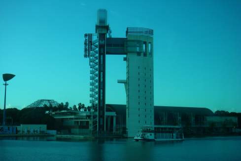 a tall building next to a body of water