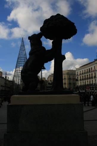 a statue of a bear holding a tree