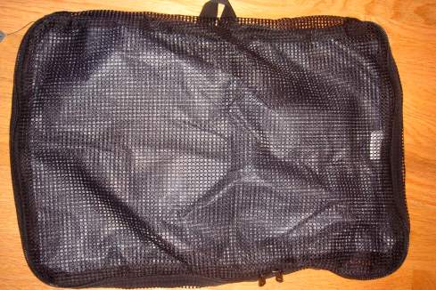 a black mesh bag on a wood surface