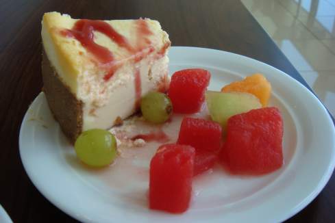 a slice of cheesecake with fruit on a plate