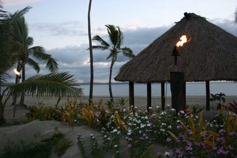 a tiki hut on a beach