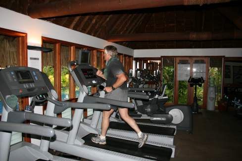 a man running on treadmills in a gym