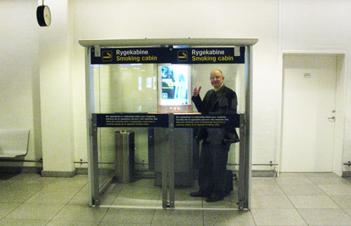 a man standing in a glass booth