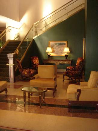 a lobby with a staircase and chairs