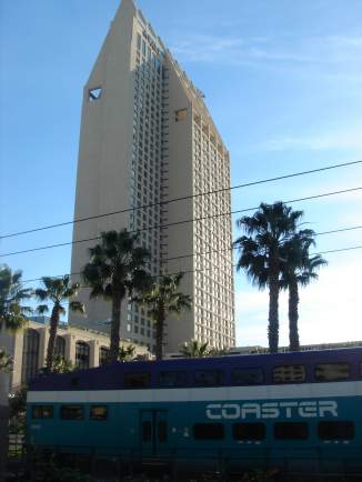 a train passing by a tall building