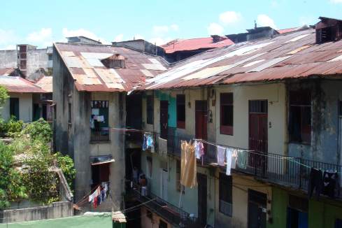 a group of buildings with clothes out of the roof
