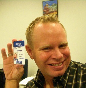 a man holding up a name tag
