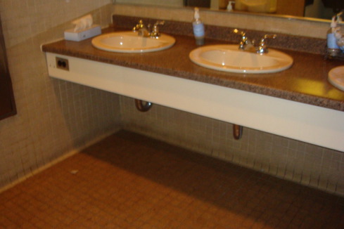 a bathroom sink with a mirror and a tile floor