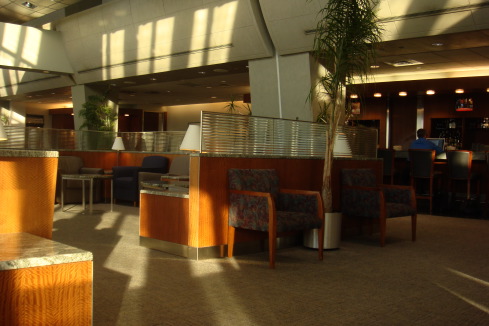 a lobby with a tree and chairs