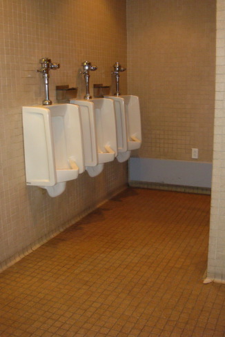a row of urinals in a bathroom