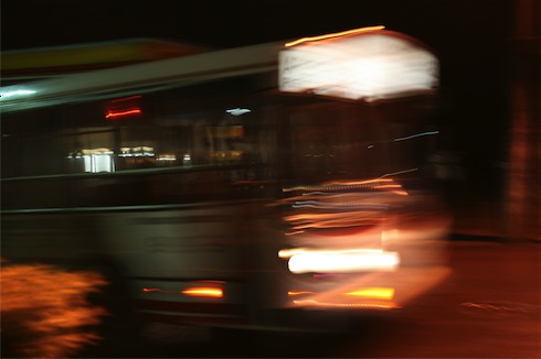 a blurry image of a bus driving down the street