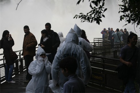 a group of people in white raincoats
