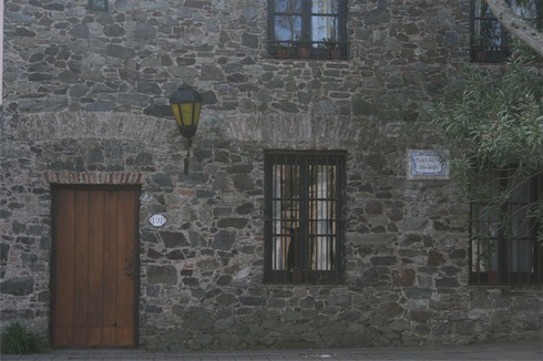 a stone building with a door and a window