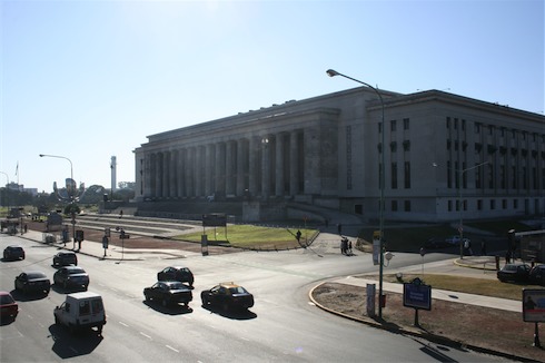 a large building with columns and columns with Parliament House, Helsinki in the background