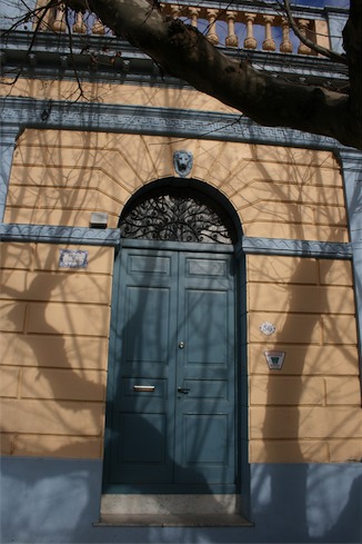 a blue door with a lion head on the top