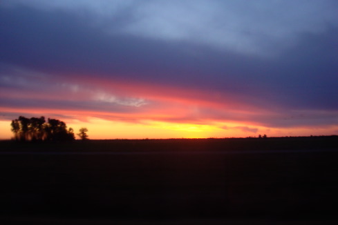 a sunset over a field