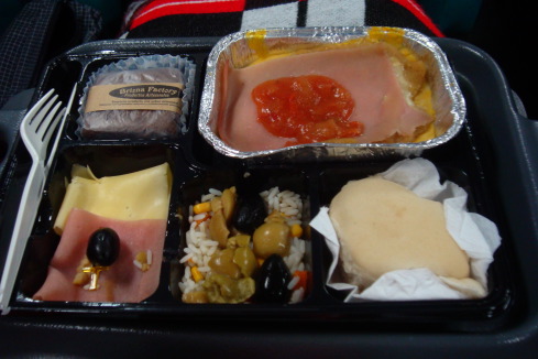 a tray of food on a bed