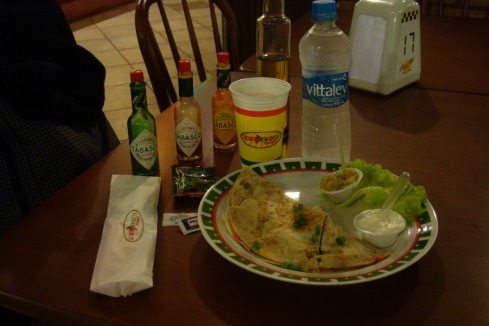 a plate of food and bottles on a table