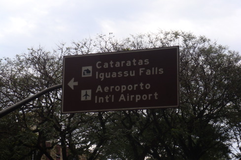 a sign with an arrow and an arrow pointing to an airport