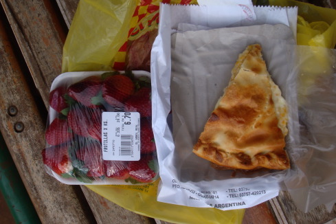 a piece of pie and strawberries in a plastic bag