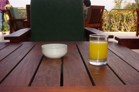 a bowl and a glass of orange juice on a table