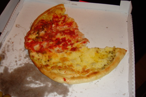 a pizza with a bite taken out of it