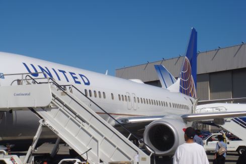 a passenger plane boarding at an airport