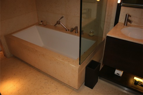 a bathroom with a bathtub and a glass shower