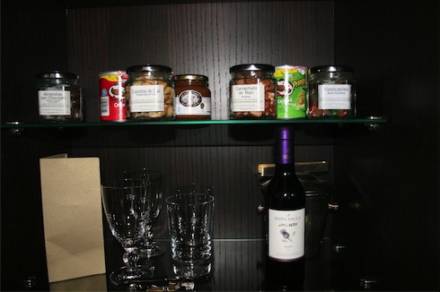 a shelf with food and wine bottles on it