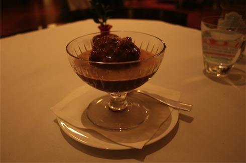 a glass bowl with a brown dessert in it
