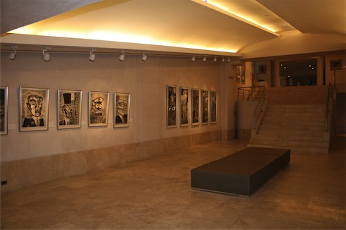 a room with a staircase and art on the wall