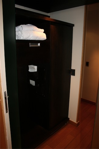 a closet with towels on top