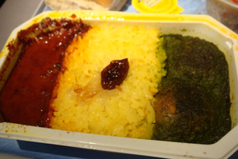 a tray of food with rice and sauce