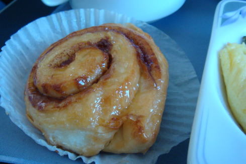 a cinnamon roll on a paper wrapper