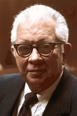 a man wearing glasses and a suit